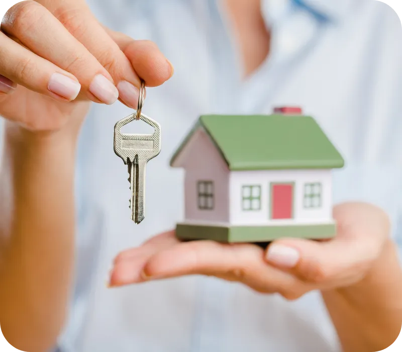 Person holding a small house model and key, symbolizing pre-listing home inspections in Central Florida with A.C.F. Home Inspections.