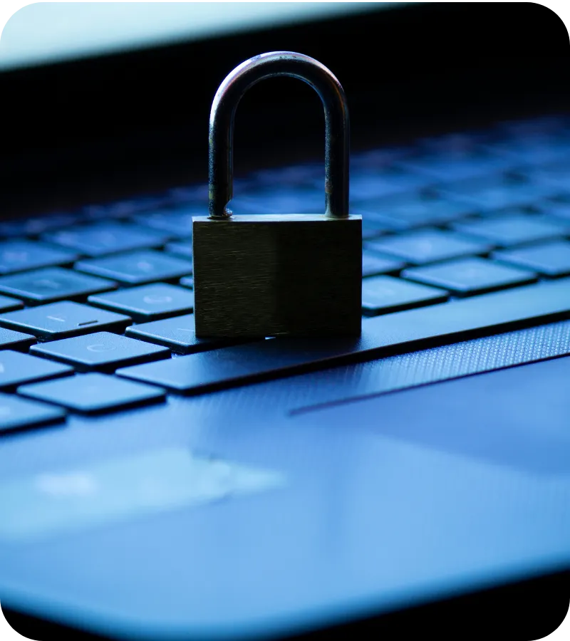 Close-up of a metal padlock placed on a laptop keyboard symbolizing online data protection and cybersecurity.