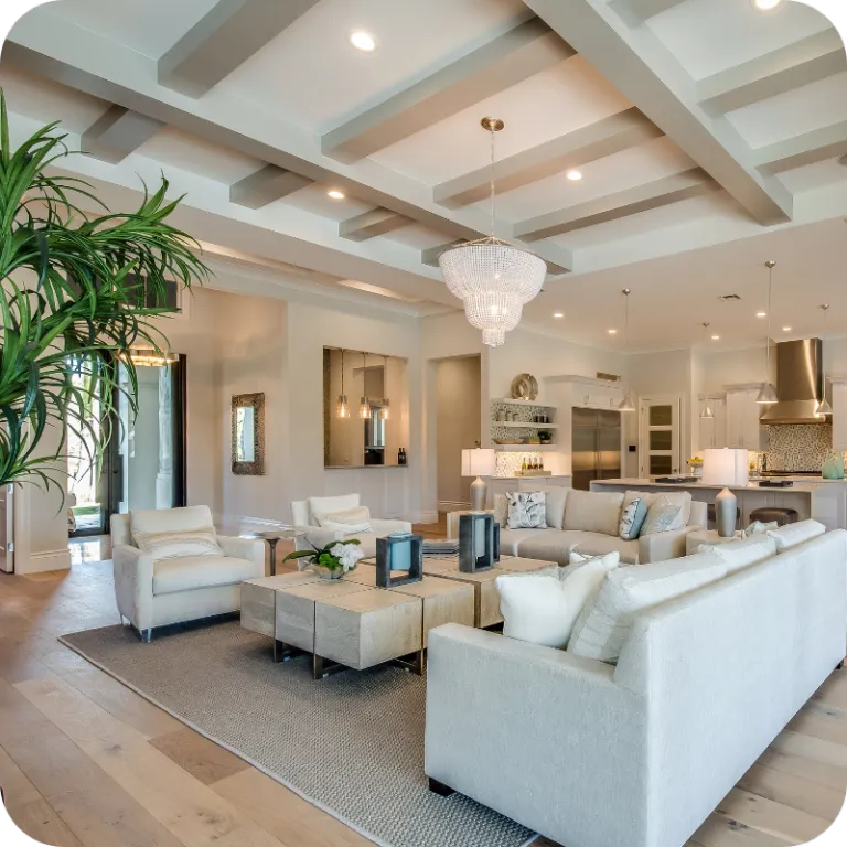 Spacious modern living room with bright lighting, neutral decor, and open kitchen area representing a well-maintained Kissimmee home ready for inspection.