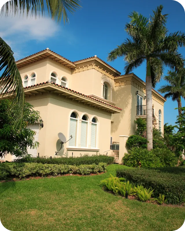 Large two-story tan house in Clermont, Florida with palm trees and manicured landscaping, representing inspected residential homes in the area.