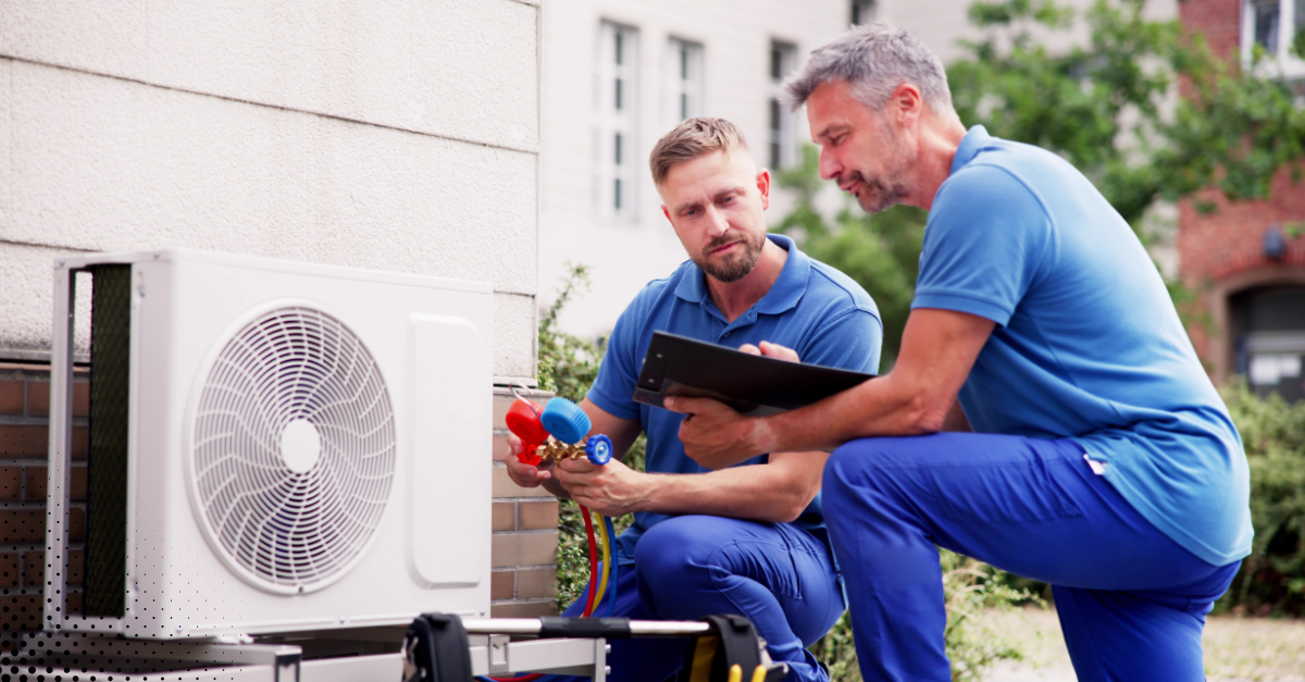 HVAC technicians inspecting an outdoor air conditioning unit. HVAC technicians inspecting an outdoor air conditioning unit.
