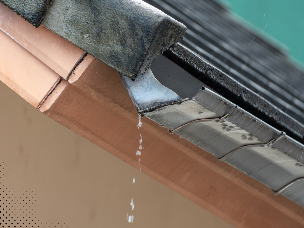 Close-up of roof edge showing damaged flashing with water dripping during rain. Close-up of roof edge showing damaged flashing with water dripping during rain.